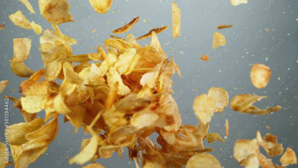 Flying potatoes chips up in the air in freeze motion