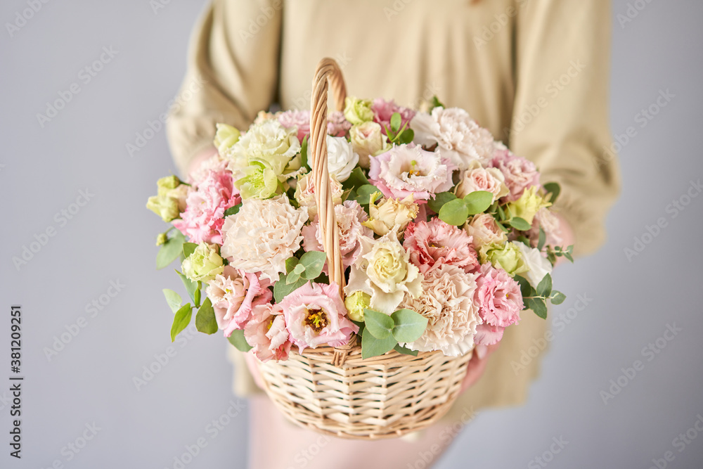 Small flower shop and Flowers delivery. Flower arrangement in Wicker basket. Beautiful bouquet of mi