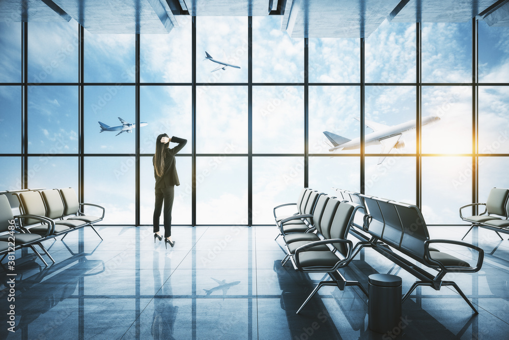 Businesswoman standing in modern airport interior