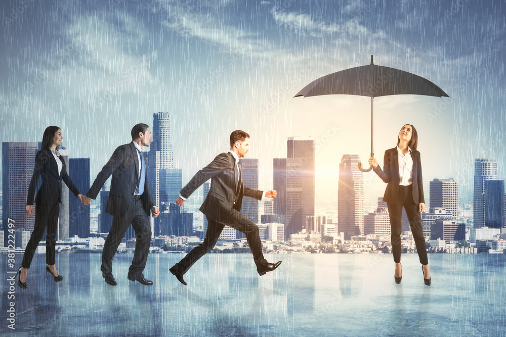 Businesspartners hiding from the rain under an umbrella