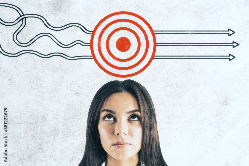 Businesswoman and drawing target with arrows