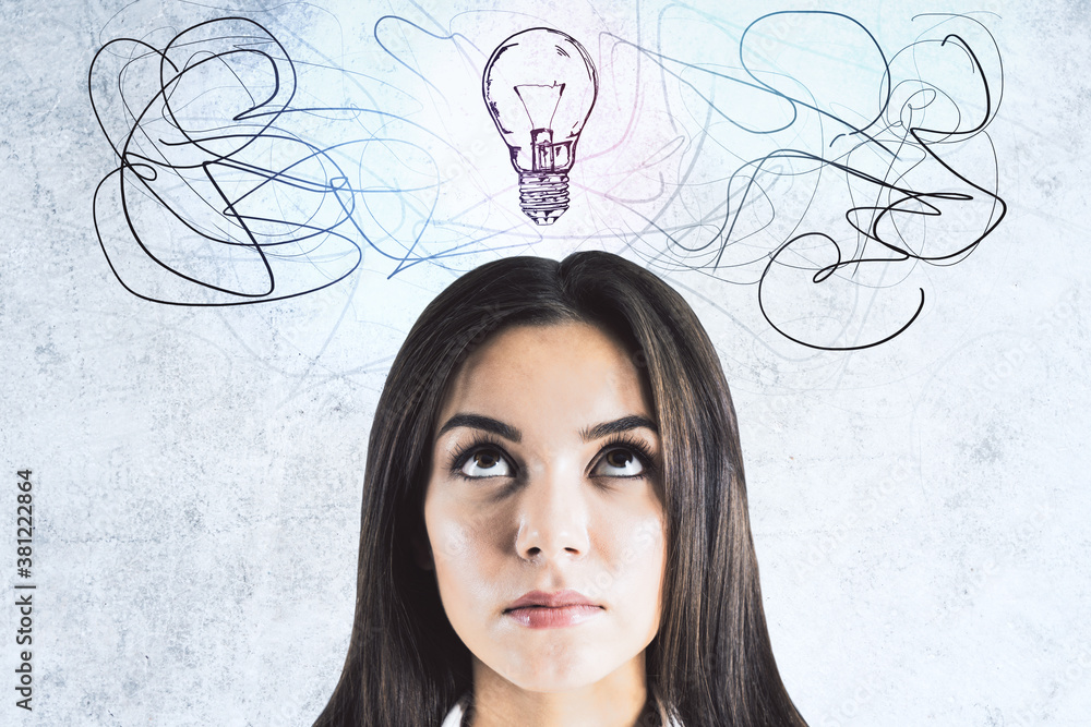 Businesswoman looking on drawing light bulbs over head