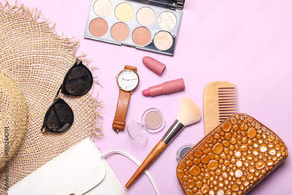 Makeup bag with decorative cosmetics and accessories on color background