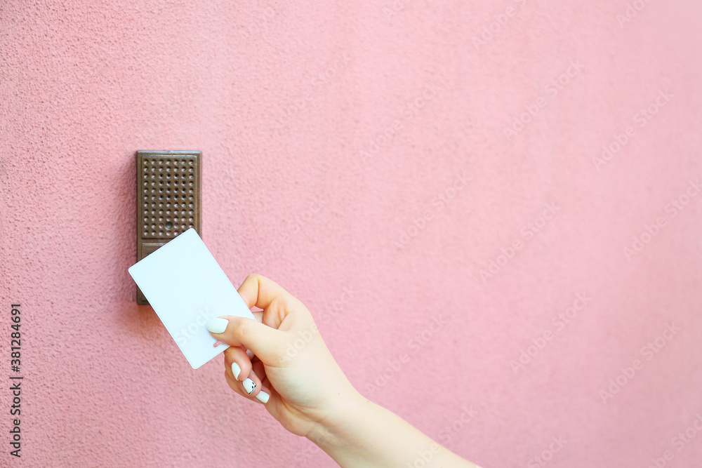 Woman using card to open door outdoors