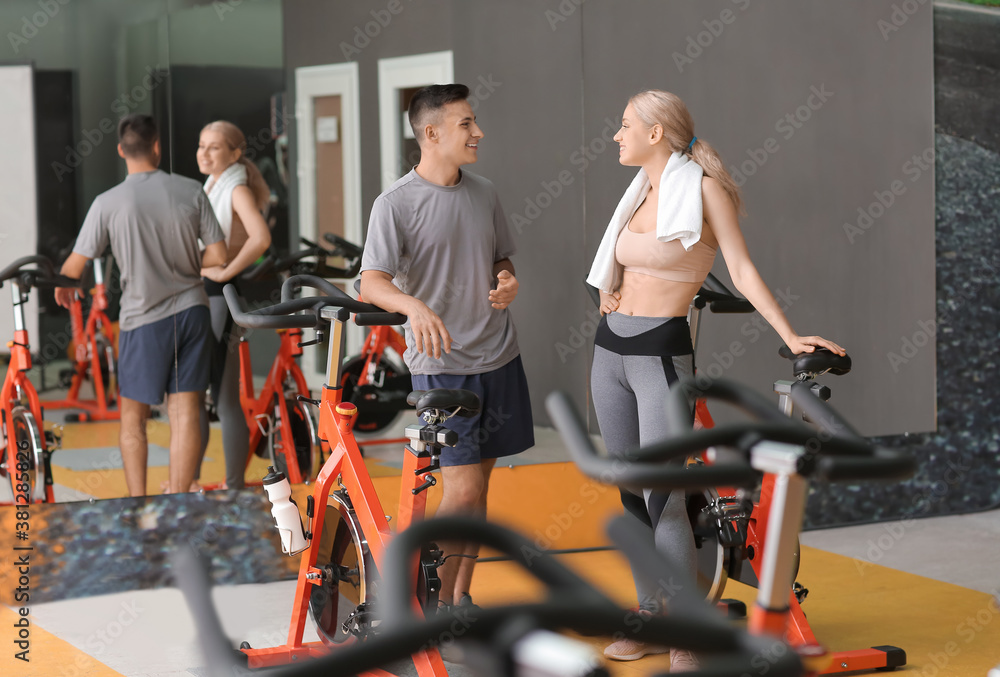 Young sporty people training in gym