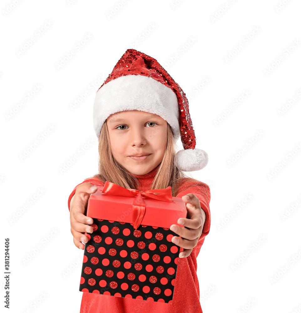 Cute little girl in Santa Claus hat and with gift on white background