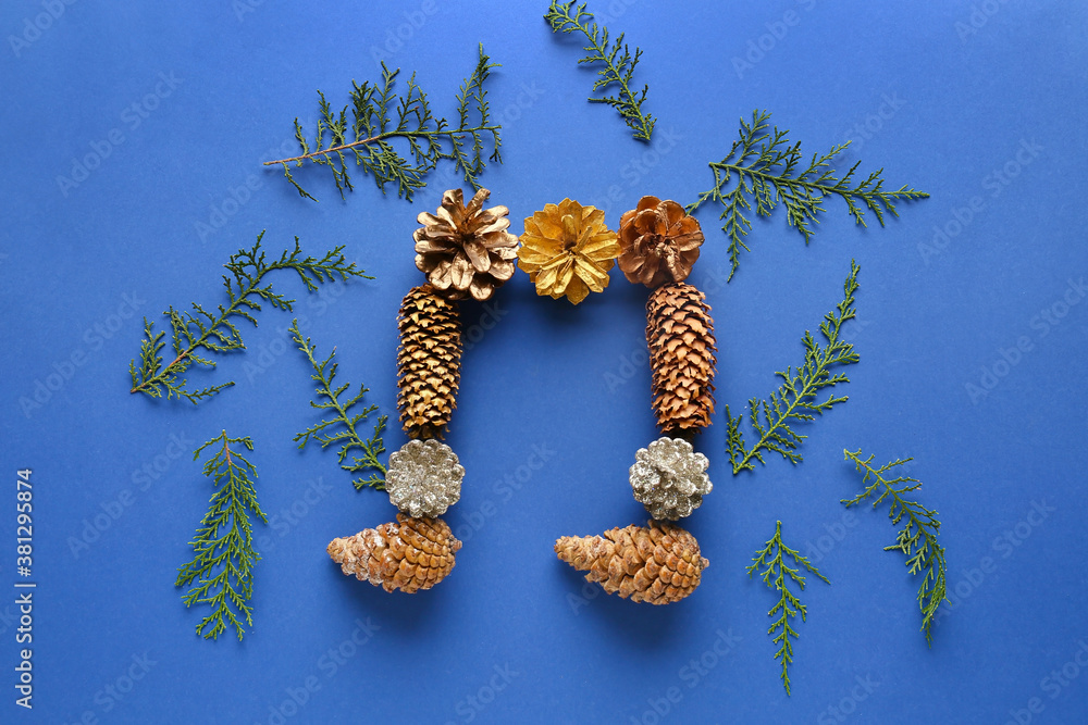 Music note made of coniferous cones on color background