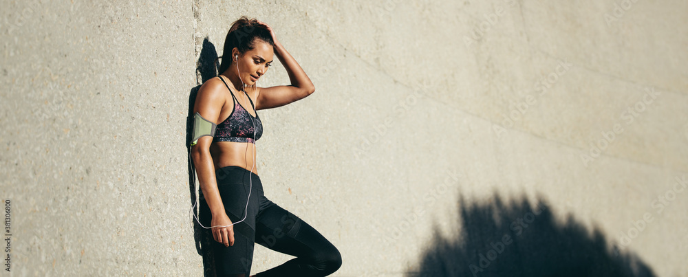 Sporty woman relaxing after running exercise