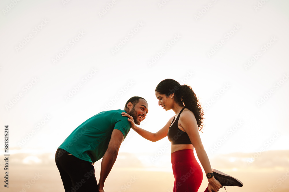 Fitness couple taking break after a run