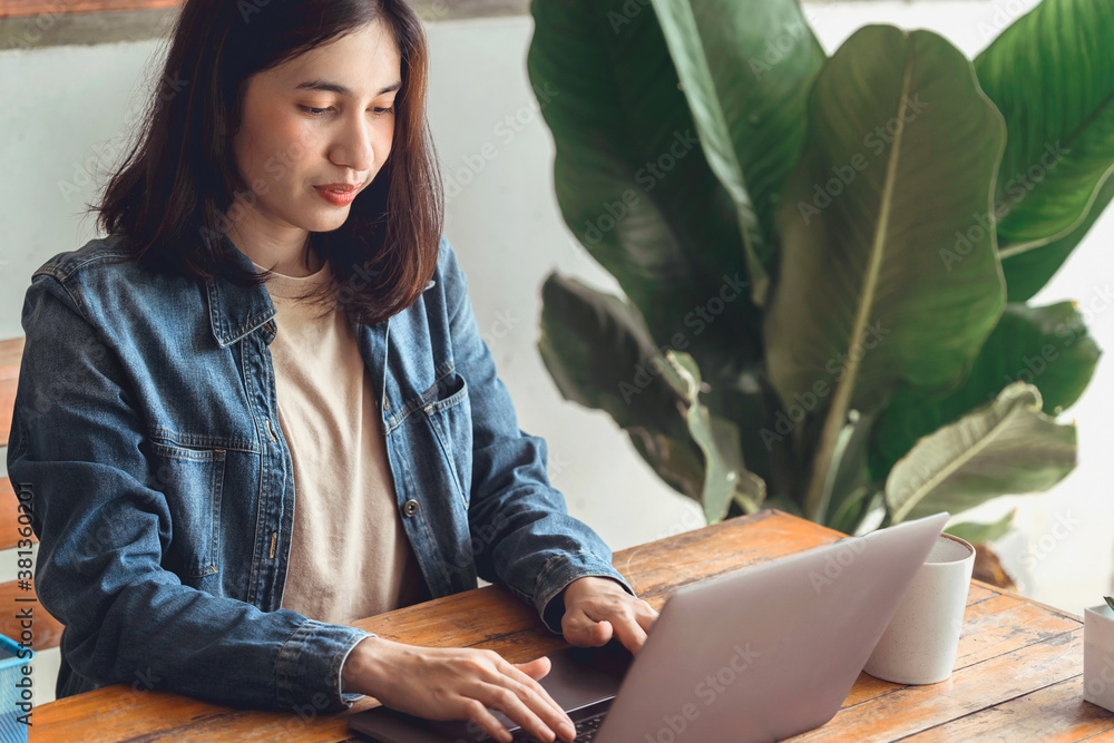 young woman working on laptop in coffee shop