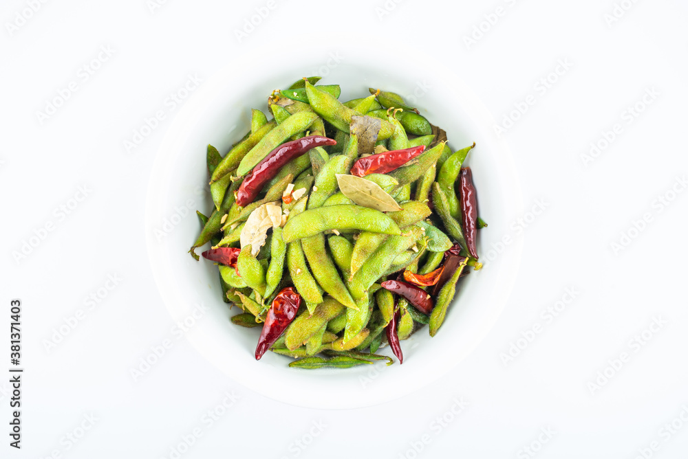 A pot of delicious spicy edamame on white background