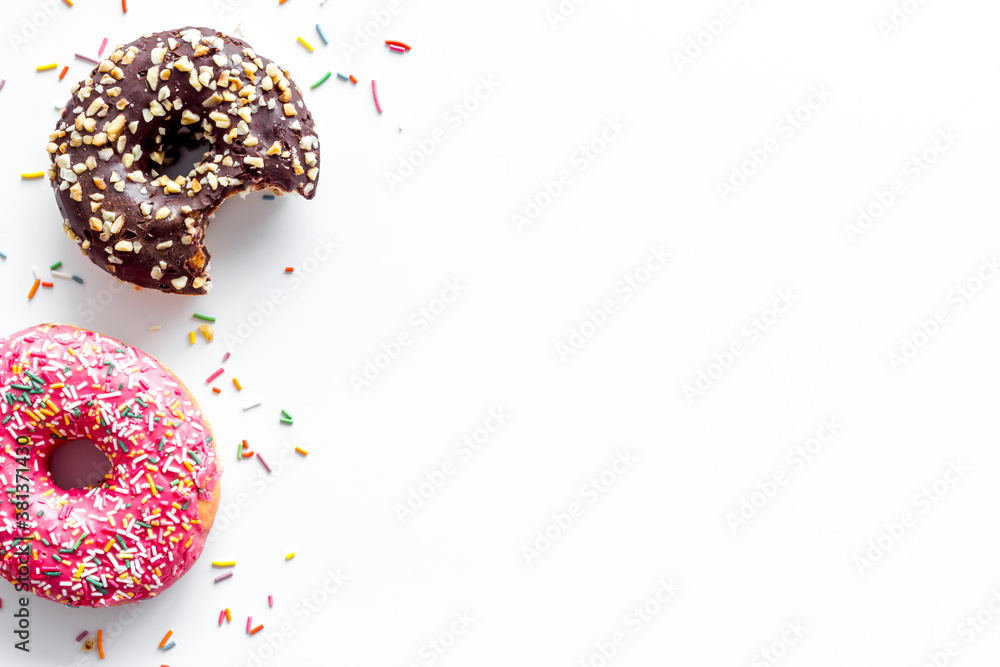 Colorful donuts pink and chocolate icing. Flat lay of bakery, above view