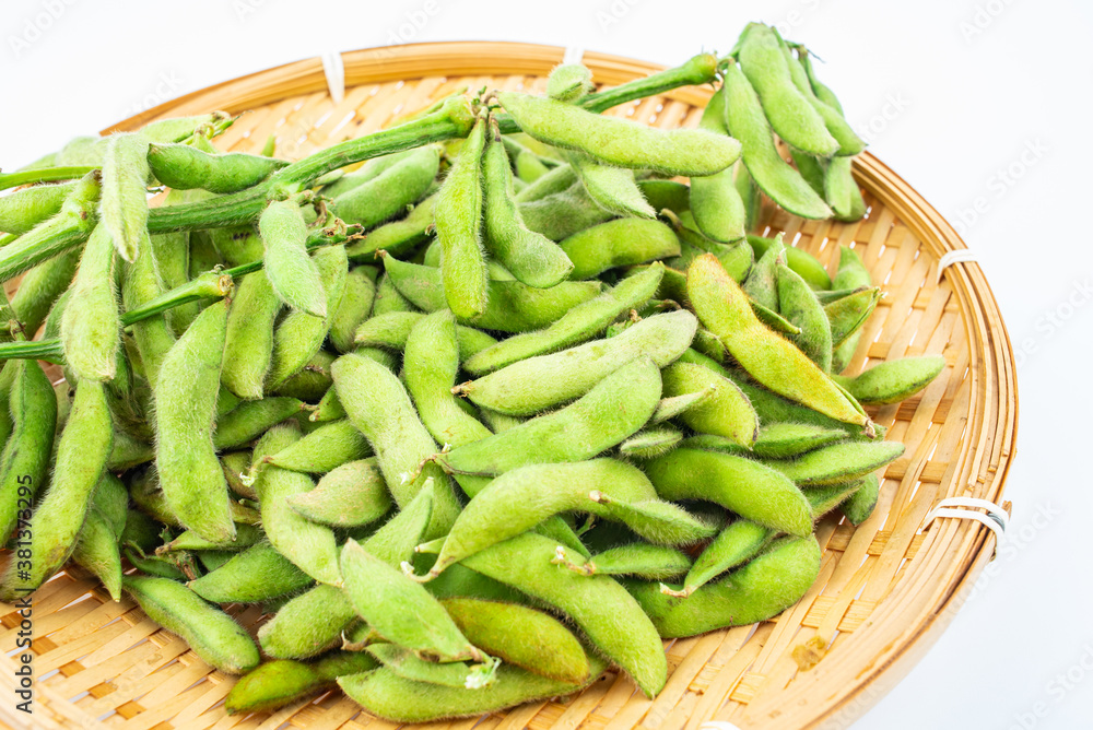 Fresh edamame in a pot on white background