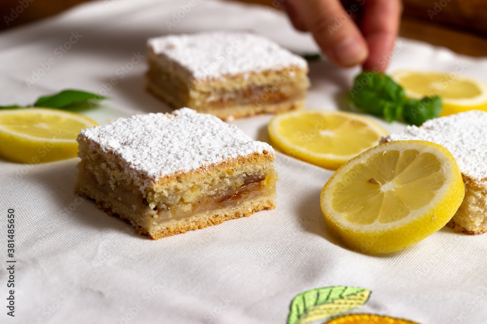 Homemade lemon pie with lemon slices alongside