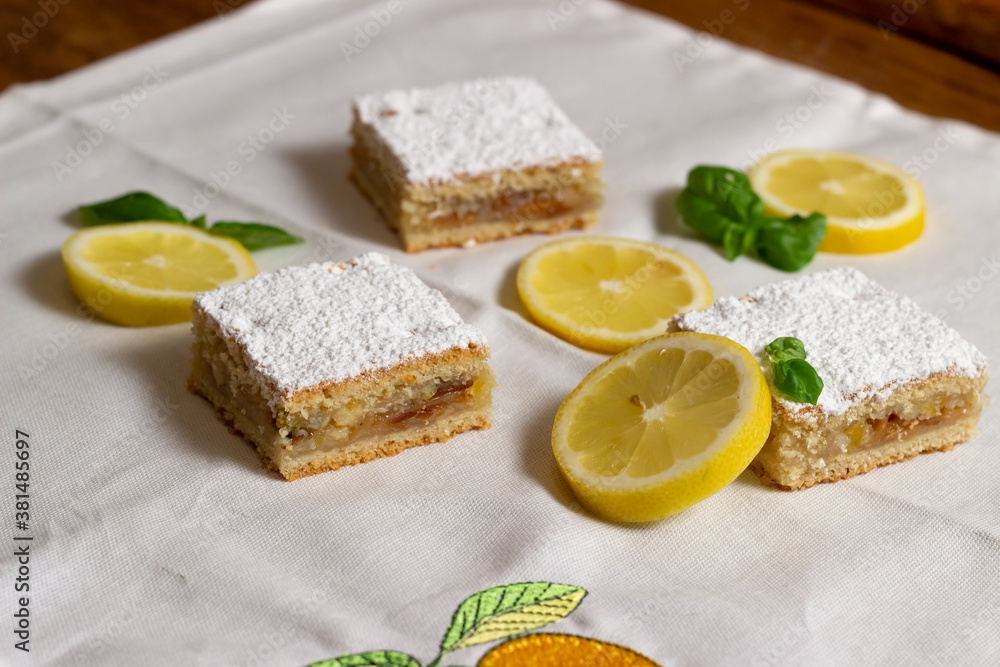 Homemade lemon pie with lemon slices alongside