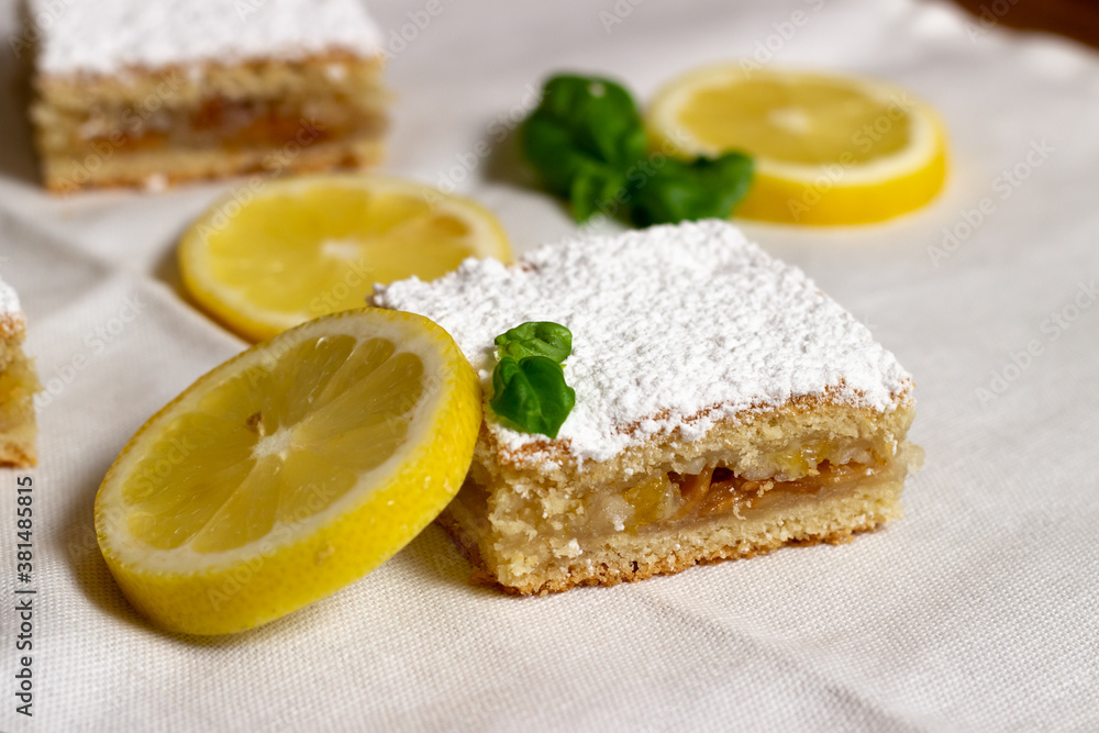 Homemade lemon pie with lemon slices alongside