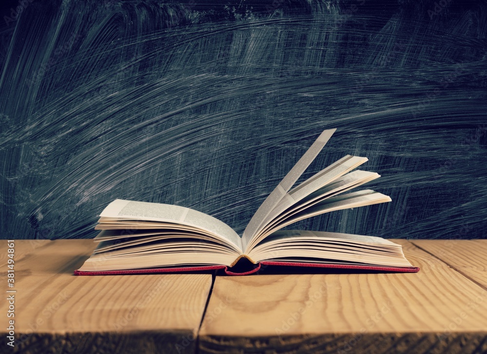 Open book on old wooden table