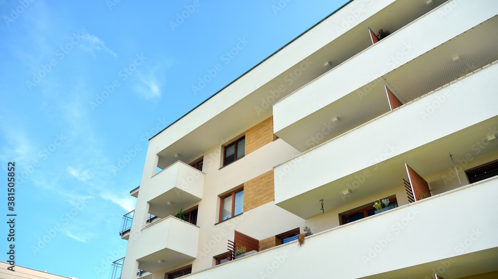 Futuristic square architecture of apartment building for real estate with big windows.