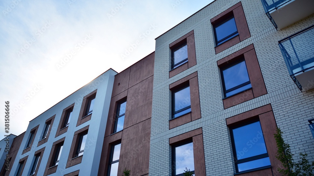 Futuristic square architecture of apartment building for real estate with big windows.