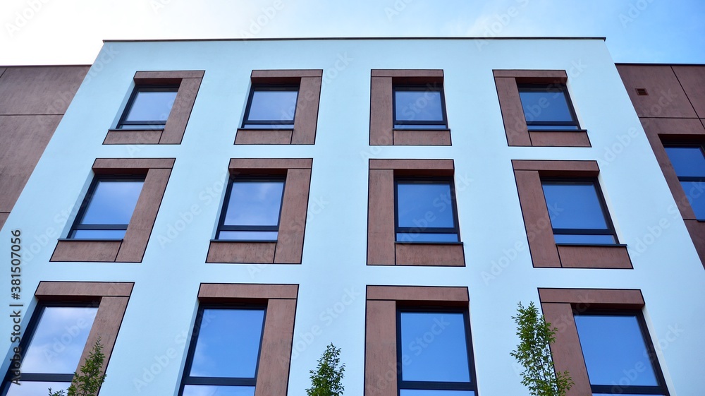 Futuristic square architecture of apartment building for real estate with big windows.