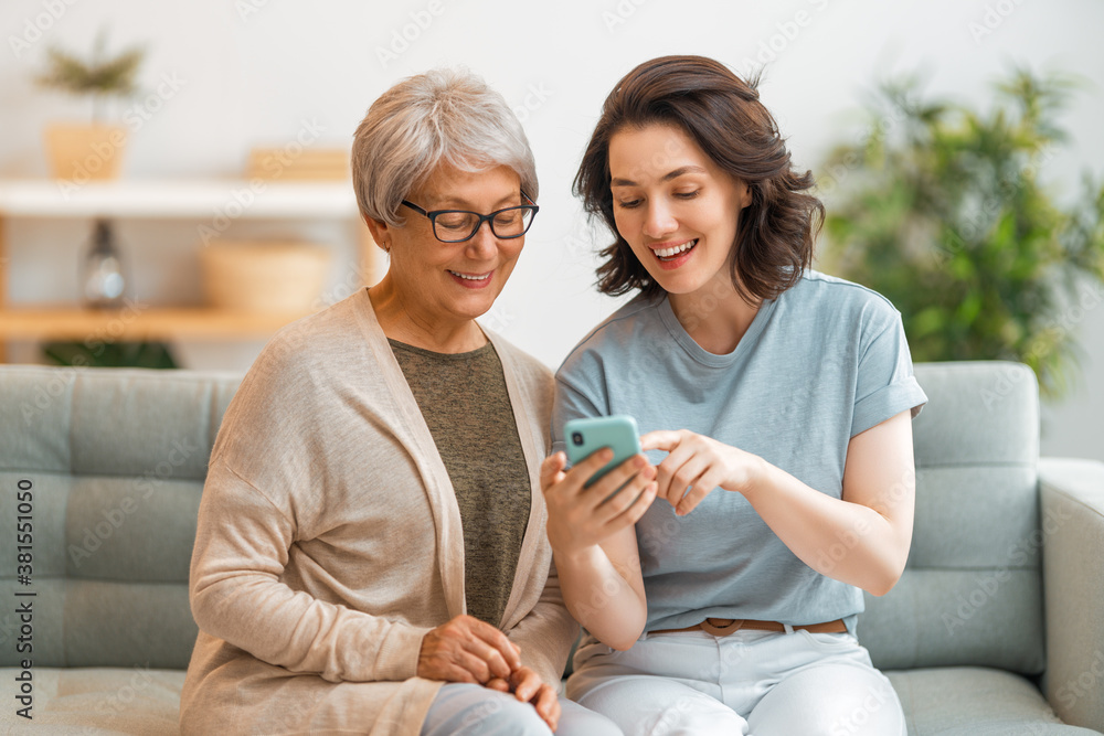 Young and senior women are using smartphone