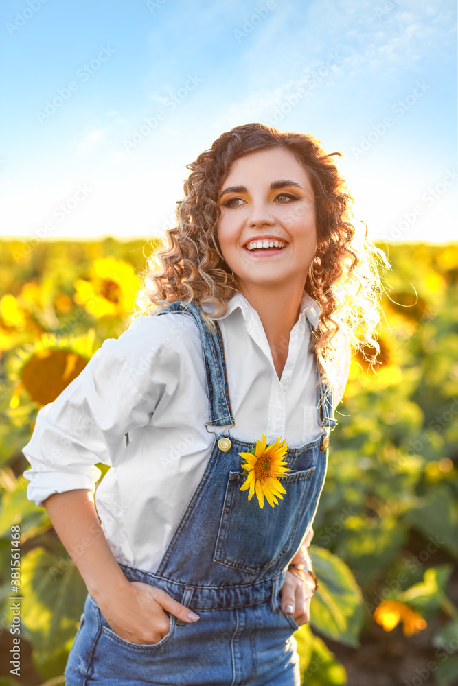 Beautiful young woman in sunflower field