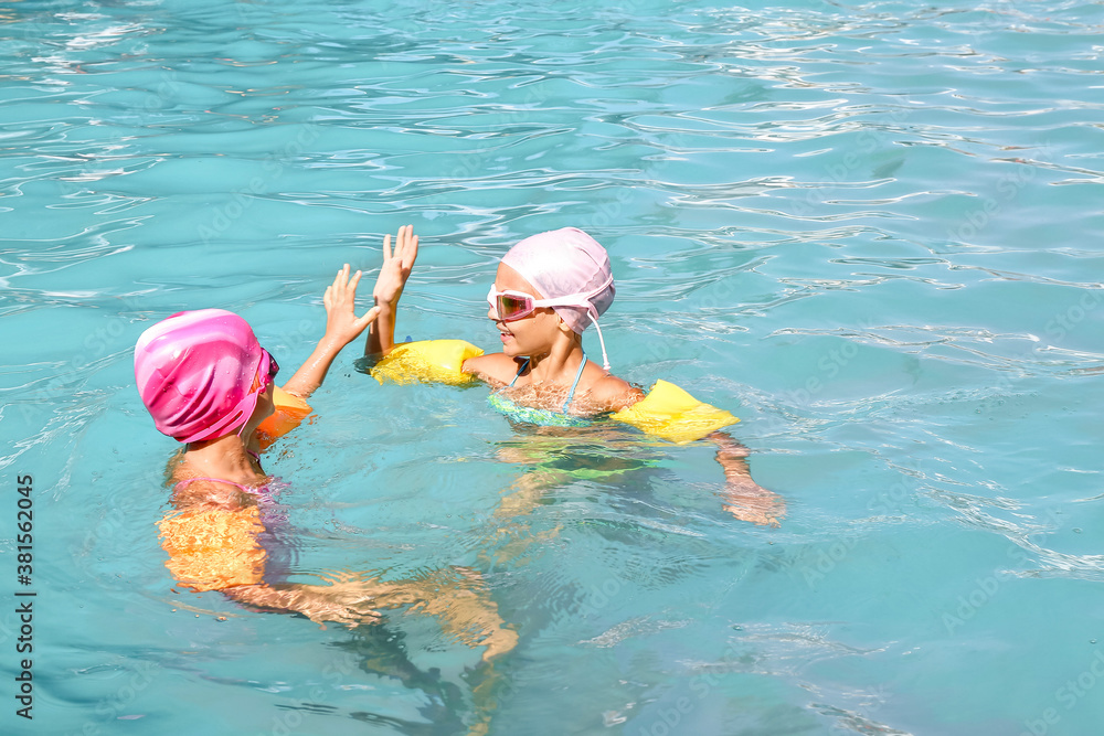 Cute little children in swimming pool