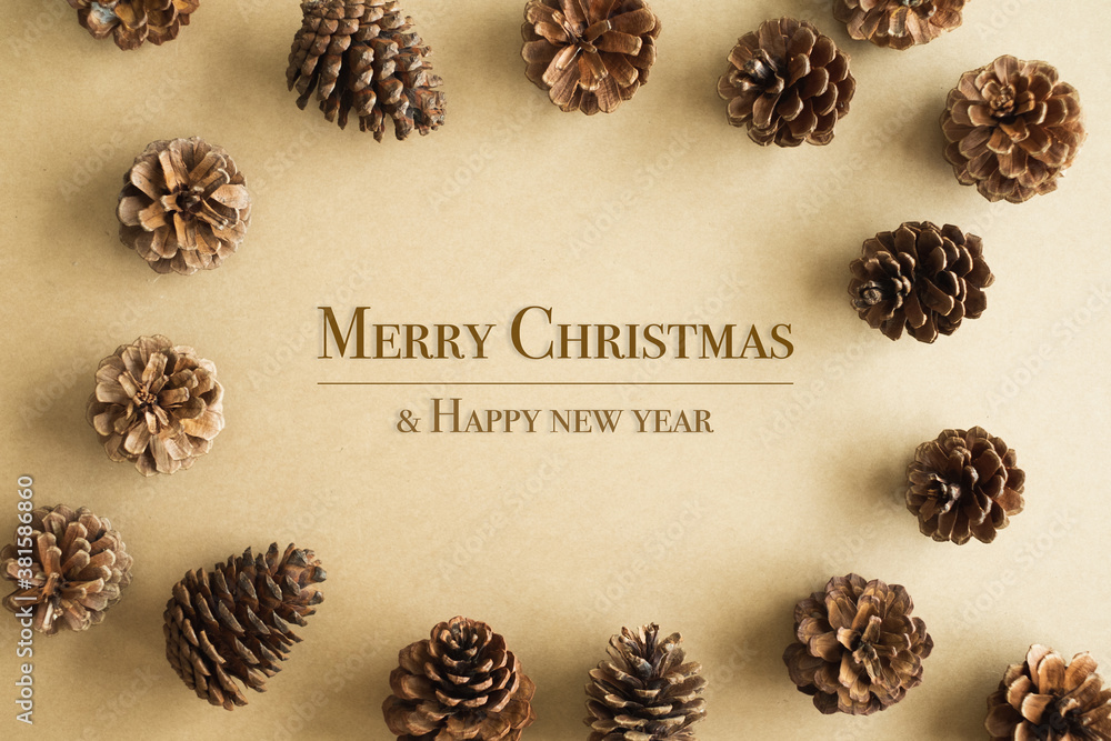 Pinecone on brown background with circle composition with wording merry christmas and happy new year