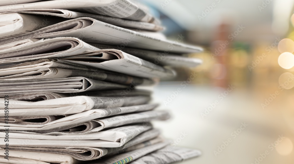 Pile of newspapers stacks on blur background