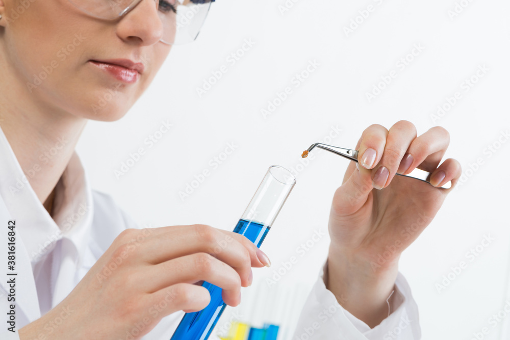 Scientist puts sample into test tube with liquid