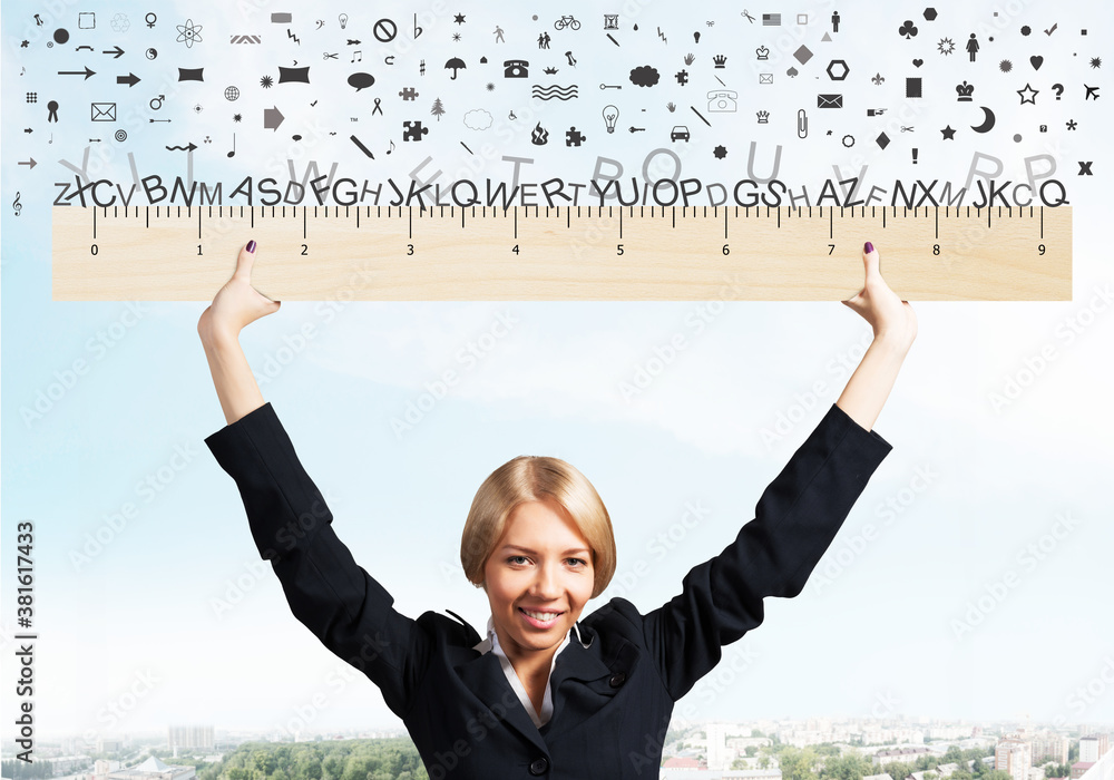 Woman in business suit holding big ruler