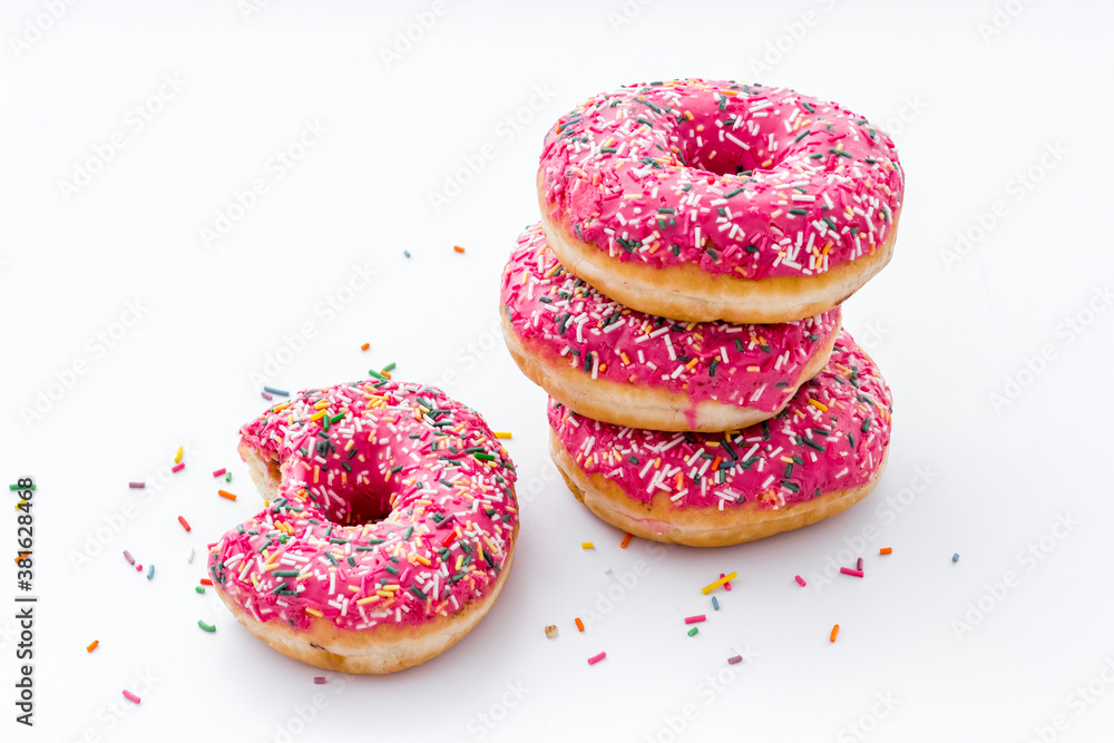 Pink berry donuts close up. Glazed and sprinkles bakery