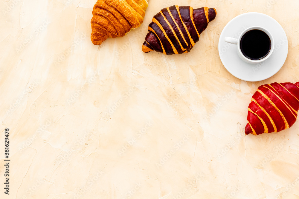 Set of coffee with croissants - chocolate, berry, classic - on stone table