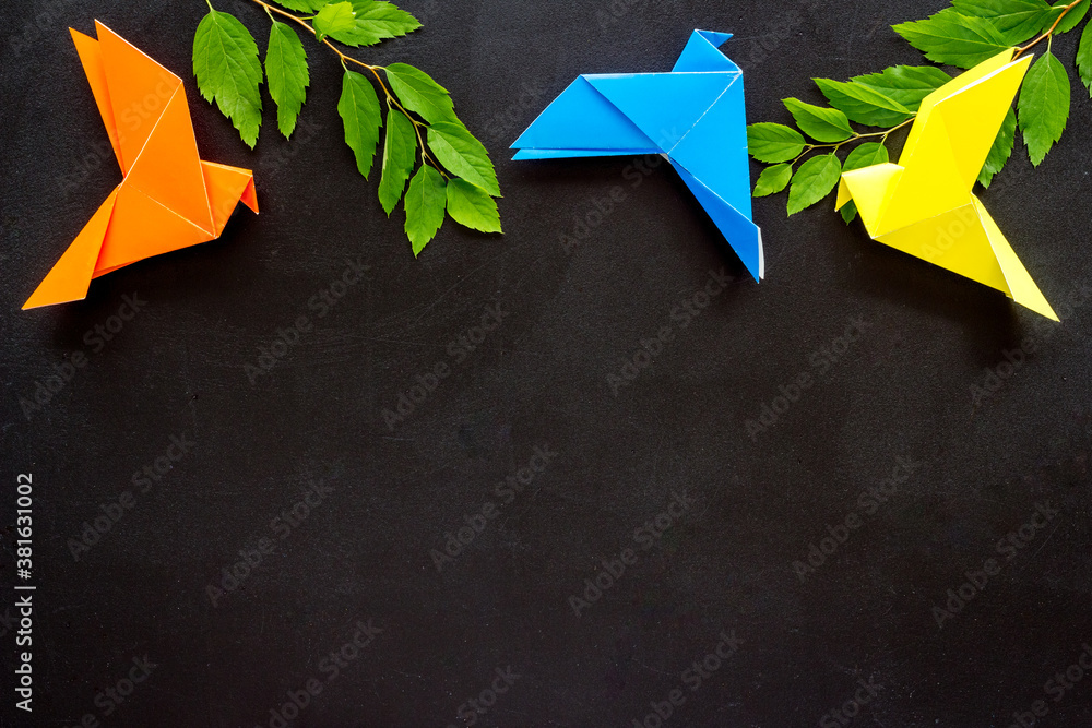 Colored origami - paper birds with leaves, overhead view