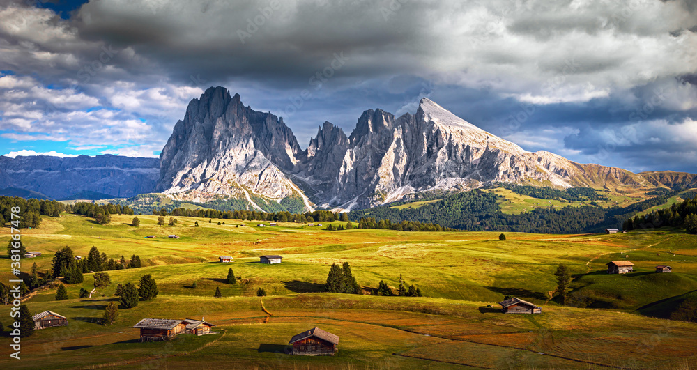 Famous Alpe di Siusi - Seiser Alm with Sassolungo - Langkofel mountain group in background at sunset