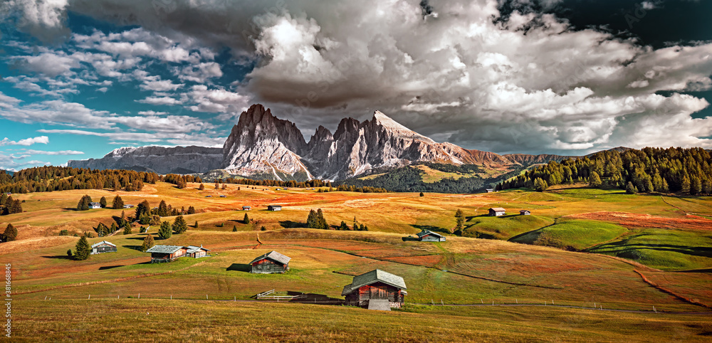 Famous Alpe di Siusi - Seiser Alm with Sassolungo - Langkofel mountain group in background at sunset