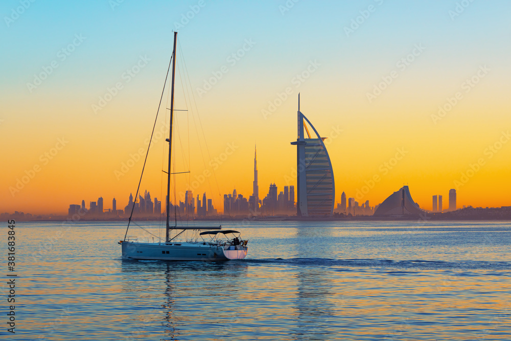 Dubai city - amazing city center skyline and famous Jumeirah beach at sunset, United Arab Emirates
