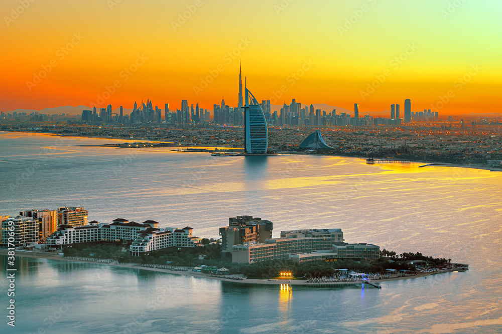 Dubai city - amazing city center skyline and famous Jumeirah beach at sunset, United Arab Emirates