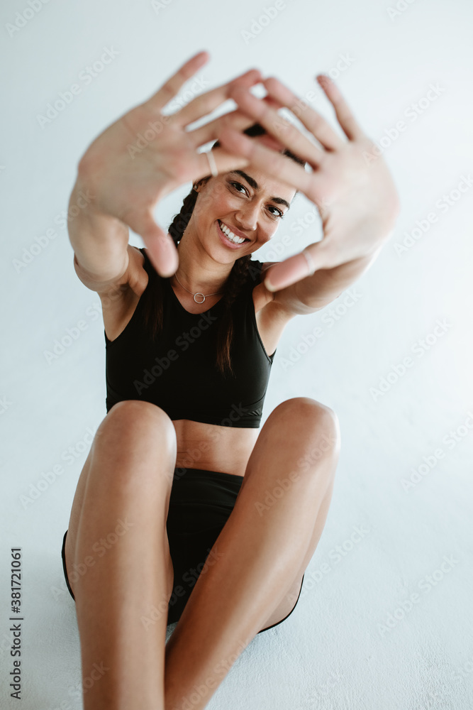 Sportswoman making finger frame