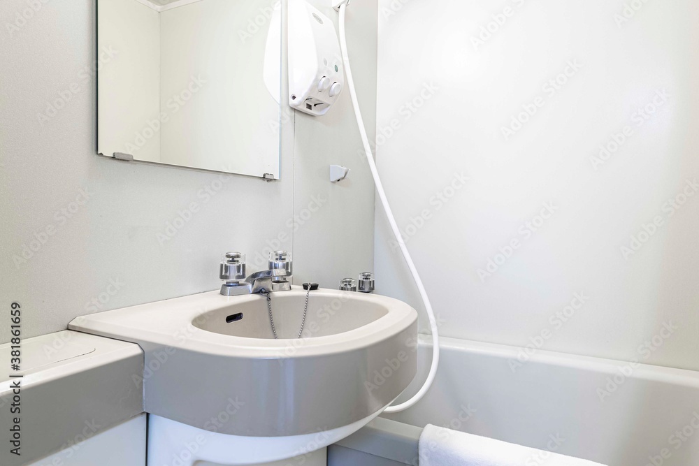 Finished bathtub and wash basin in a small shower room at Japanese hotel