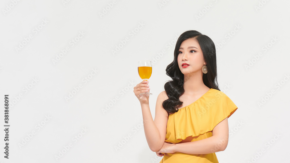 beauty cheerful girl in yellow dress posing in studio on white background