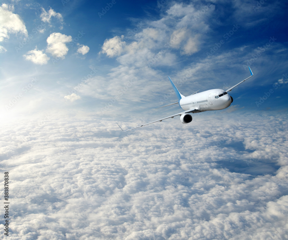 Landscape with airplane is flying in the blue sky and white clouds.