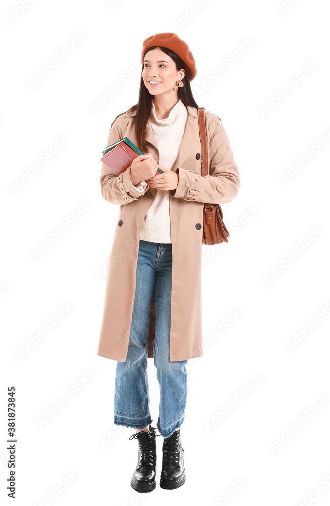 Beautiful young woman with books on white background