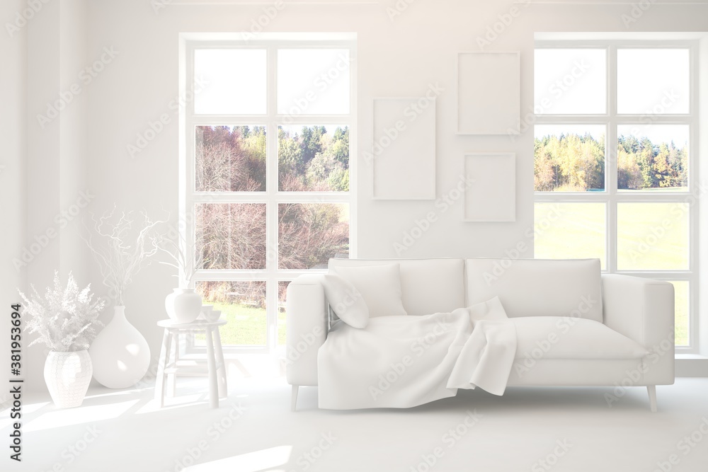 Stylish room in white color with sofa and autumn landscape in window. Scandinavian interior design. 