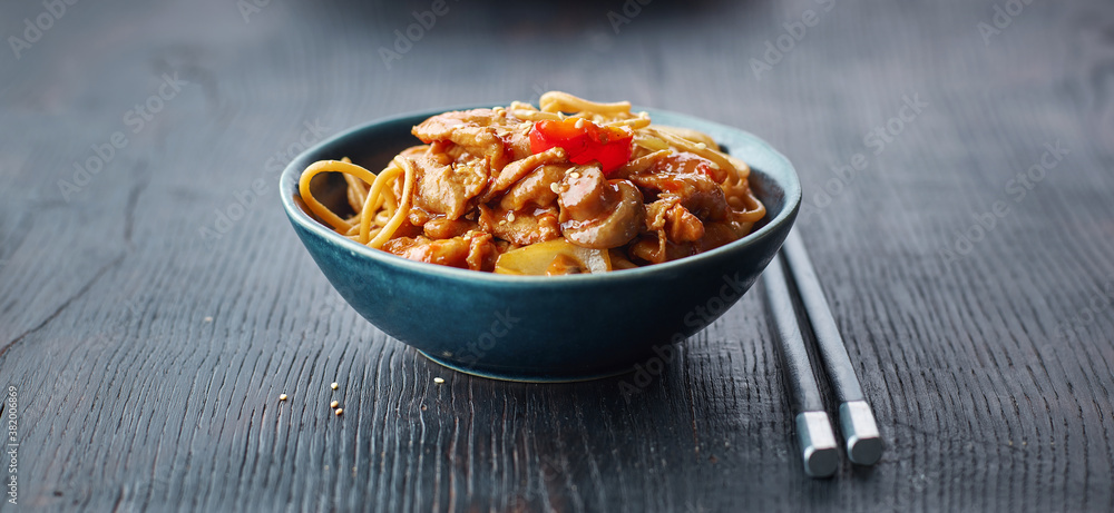 fried noodles and vegetables with hot chicken sauce