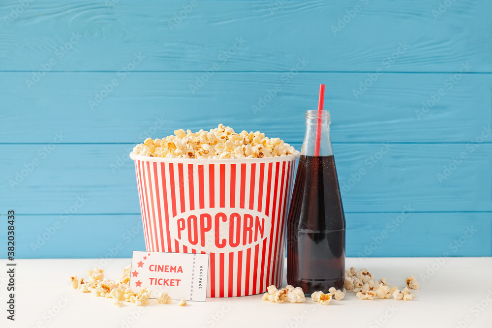 Composition with popcorn, cola and cinema tickets on table