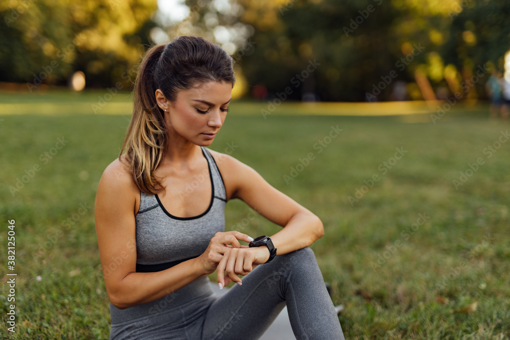 Looking at her wristwatch.