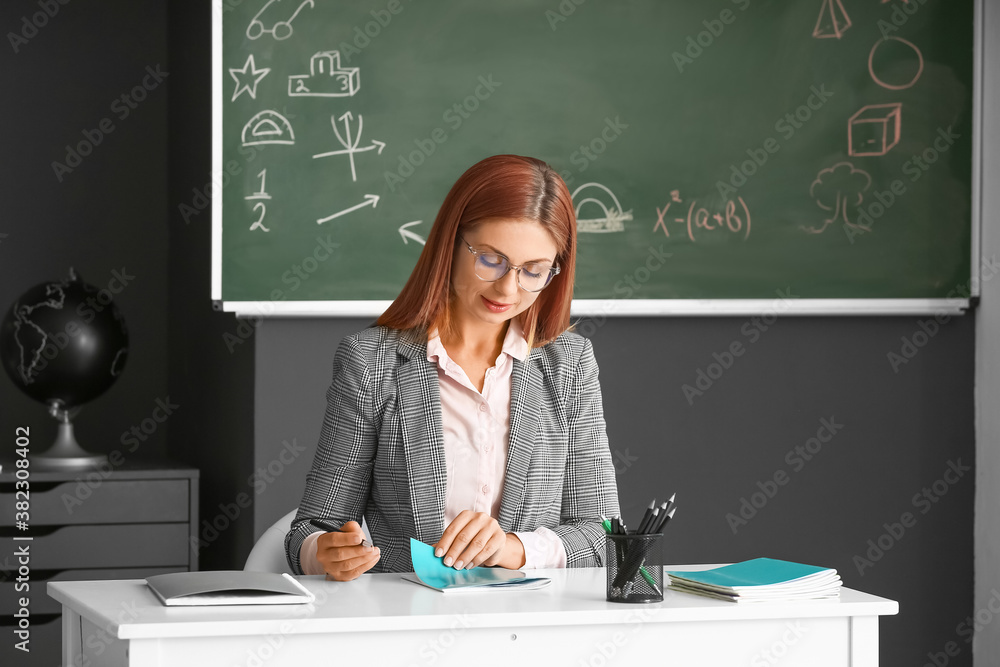 Portrait of beautiful teacher in classroom