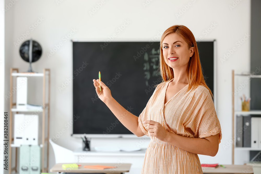 Portrait of beautiful teacher in classroom