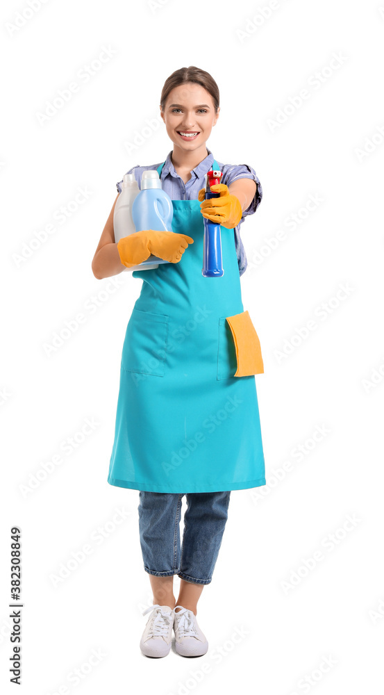 Young woman with cleaning supplies on white background